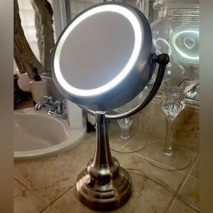 Double sided makeup vanity mirror with ring light.